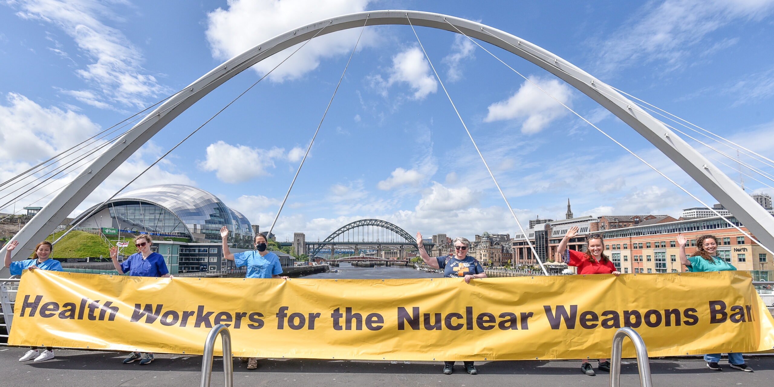 Medact North East dropping a banner at the Millennium Bridge, Newcastle, in support of TPNW, 18th June 2021.