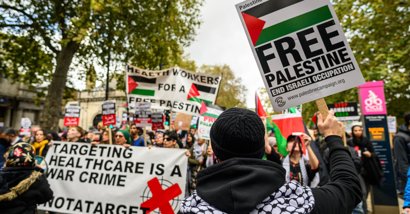 Health workers join the October 28th London march for Palestine, with banners reading 'Targeting Healthcare is a War Crime', and 'Health Workers for a Free Palestine'
