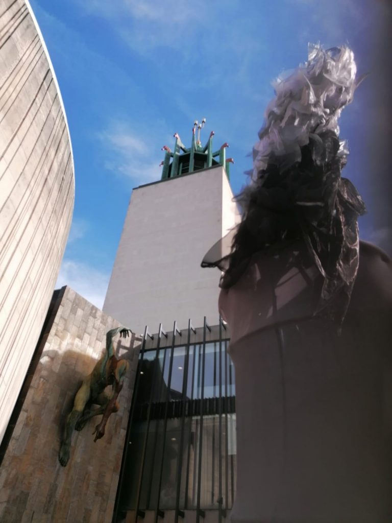 A prop model incinerator blowing 'smoke', in front of state of a man on the wall of Newcastle Civi Centre Landmark