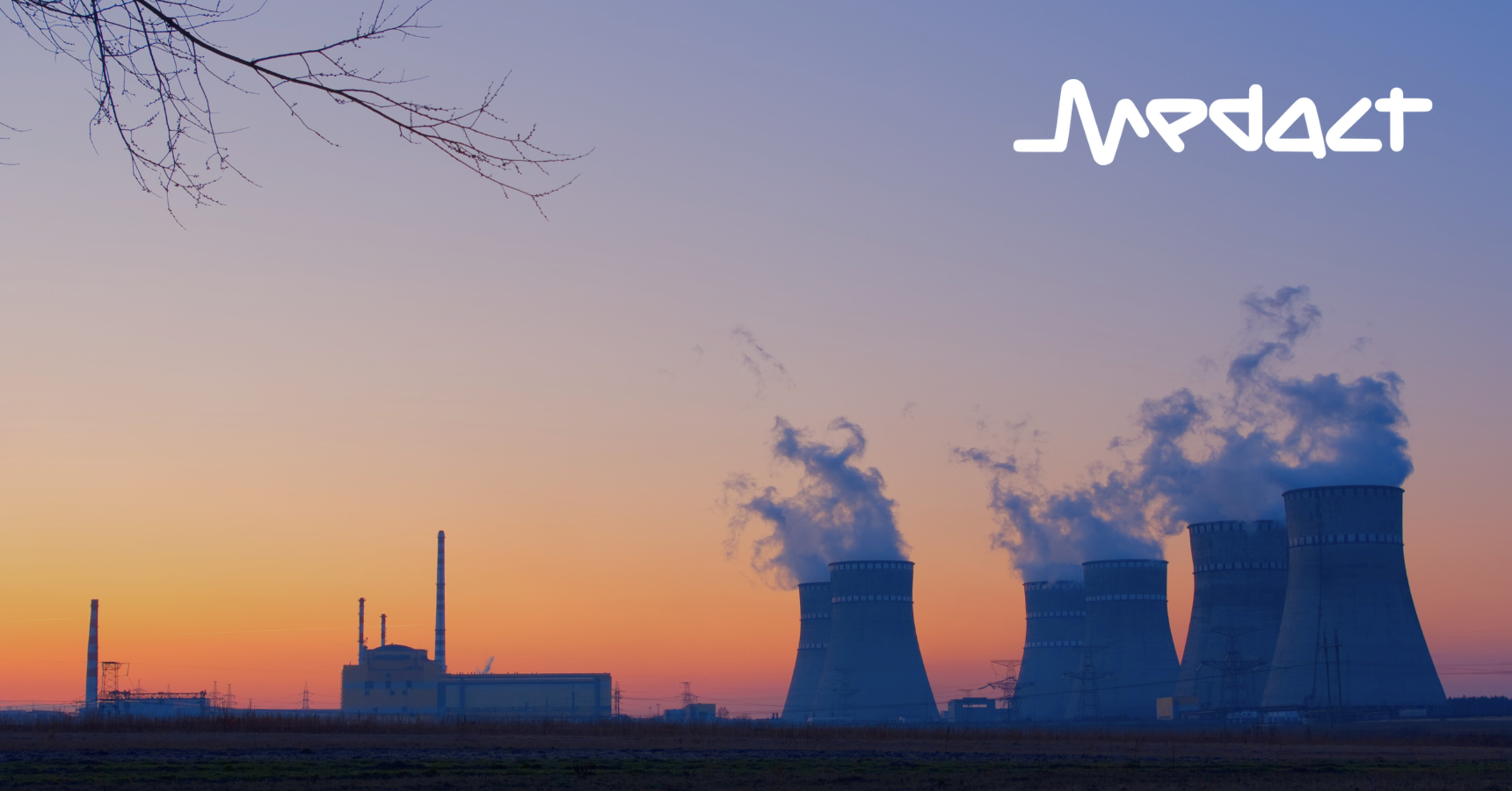 A nuclear power plant releasing smoke during sunset